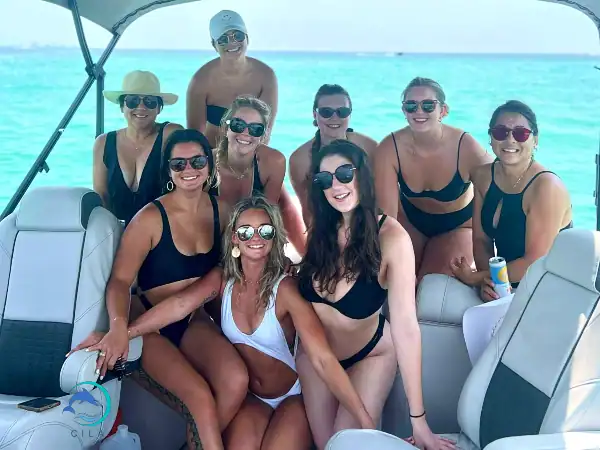 Vibrant group enjoying a boat trip at Crab Island, snorkeling and relaxing in crystal-clear waters.