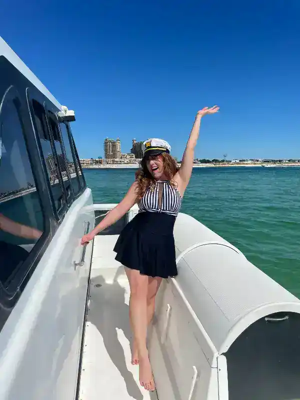 Lady wearing captain's hat on a yacht in Destin