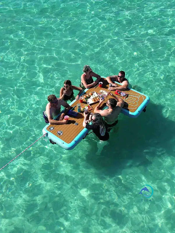 Floating crab island with a dining table, friends enjoying food on the water.