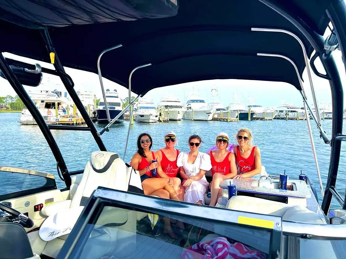A group of bachelorettes sitting on the back of a pontoon boat in Destin, Florida