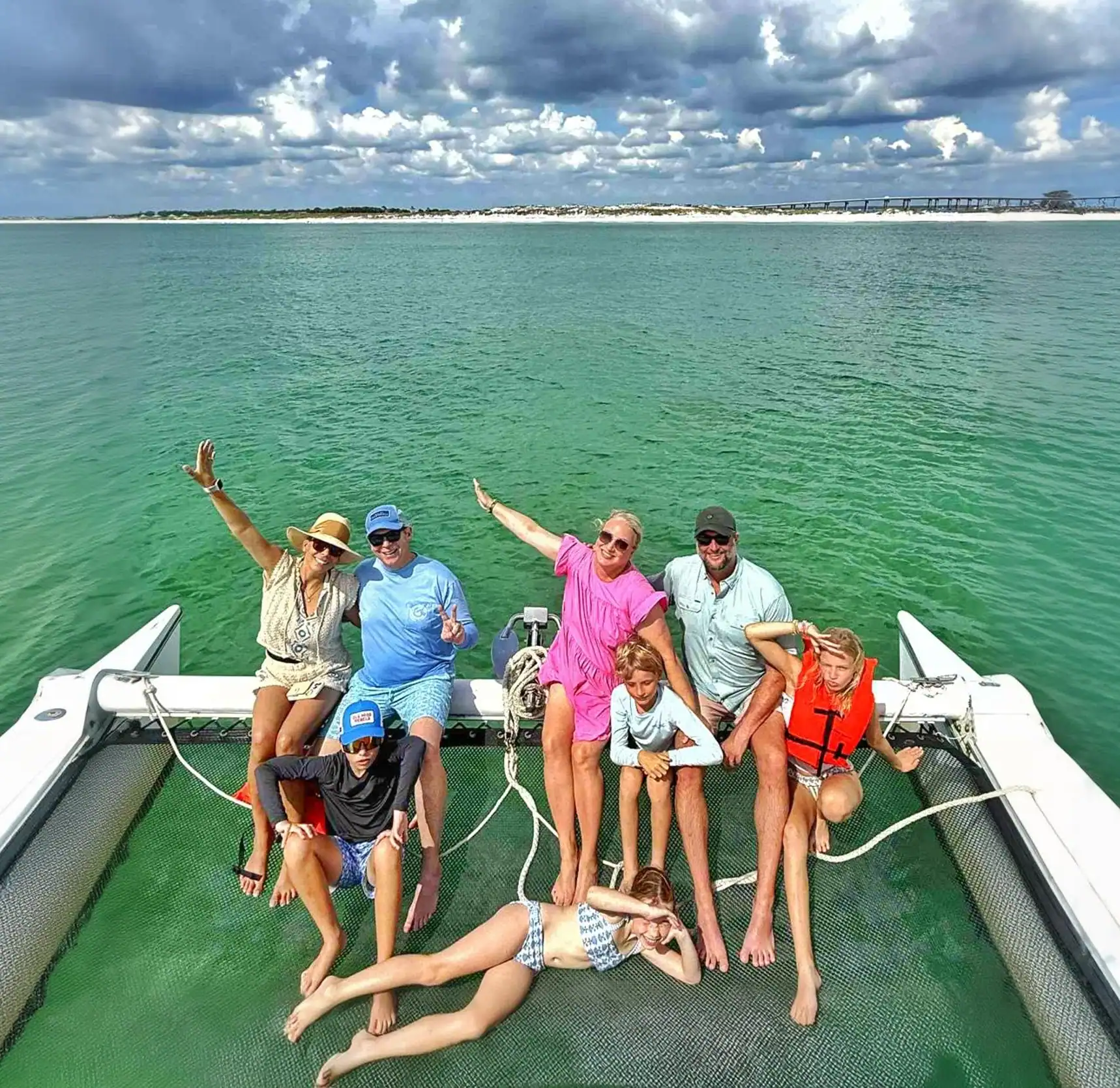 Family on the net of Lady Delana catamaran in Destin, Florida