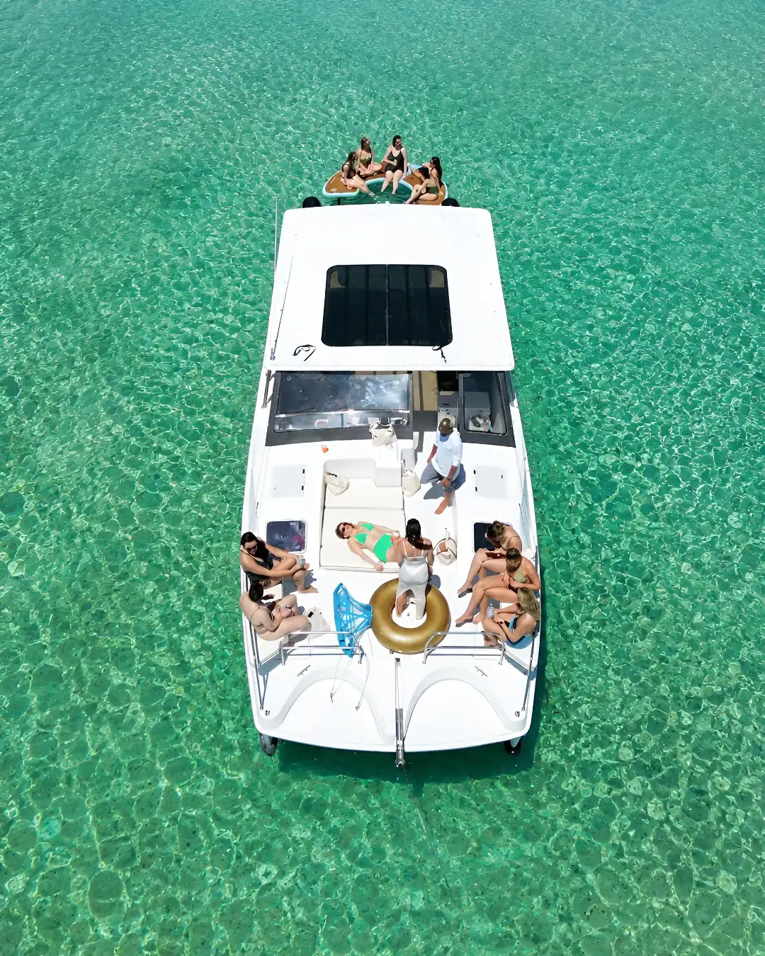 30a Bachelorettes sitting on the front of the Gemini Catamaran anchored at Crab Island