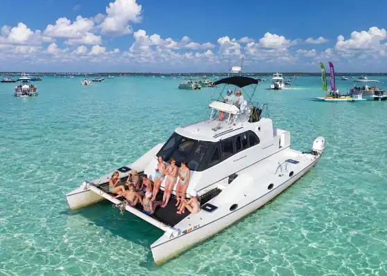 30A Bachelorettes on the net of a white catamaran at Crab Island