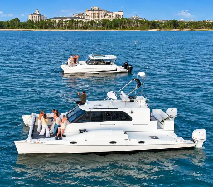 Two catamarans leaving Baytowne Marina headed for Crab Island