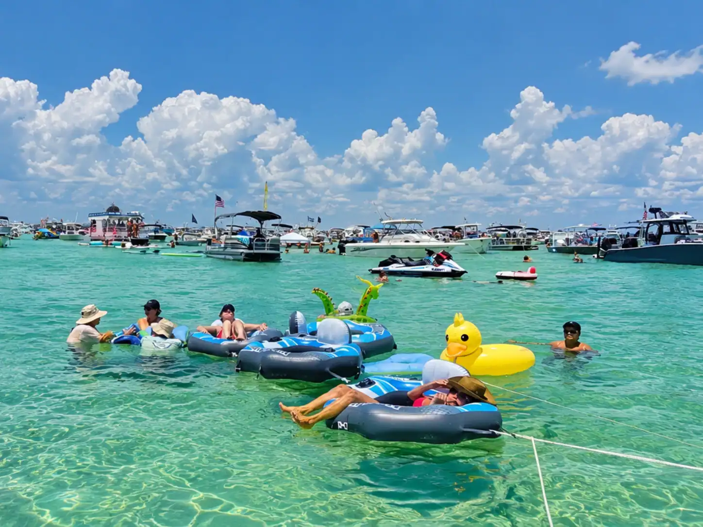 People on floats at Crab Island on a beautiful sunny day at high tide
