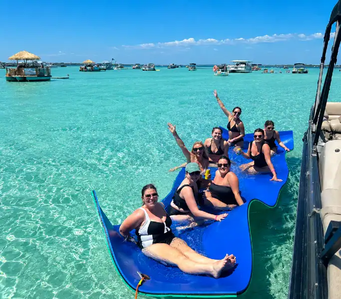 Group relaxing on a floating mat beside a private pontoon